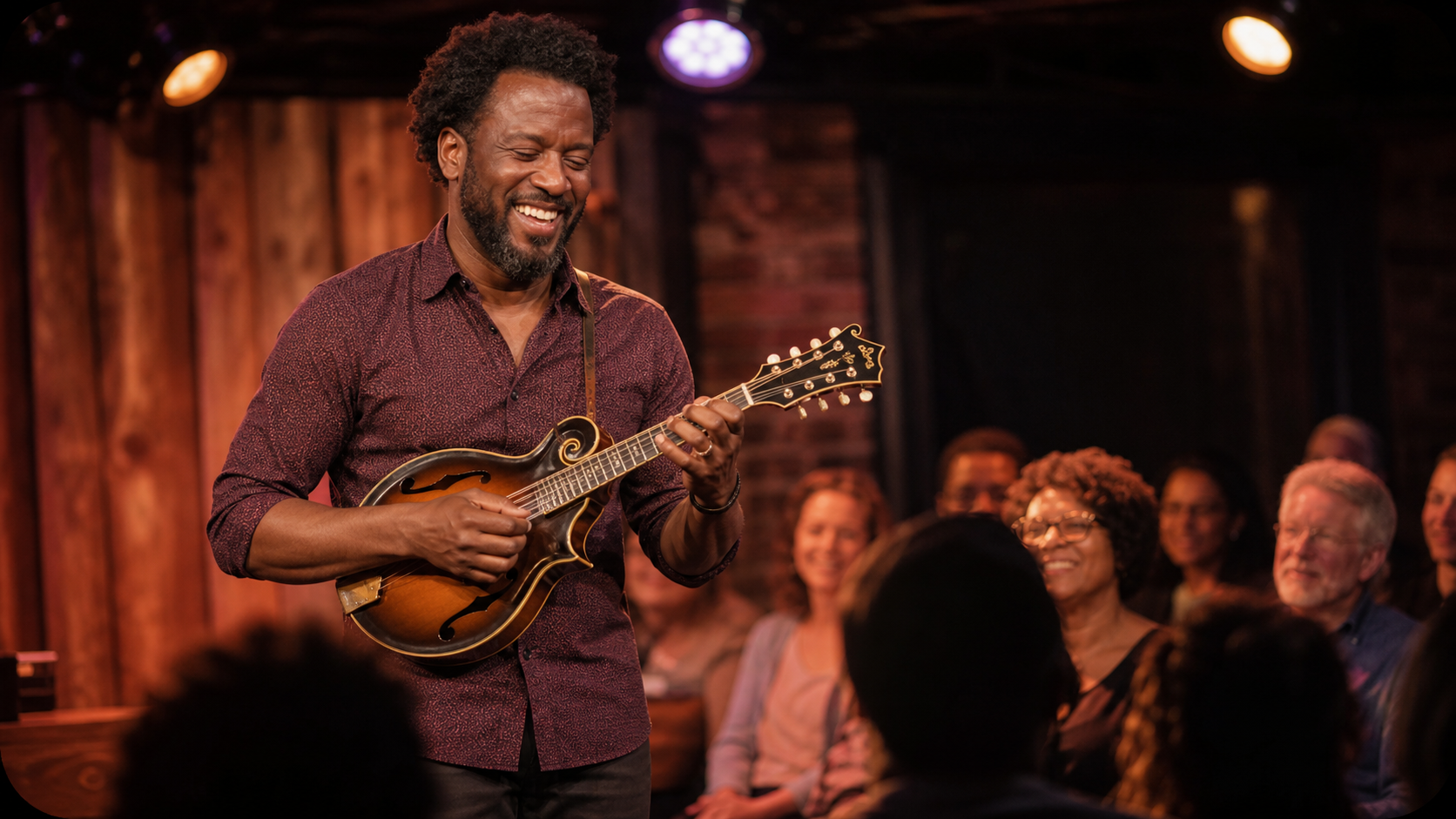 A Black mandolin player performing for an appreciative crowd